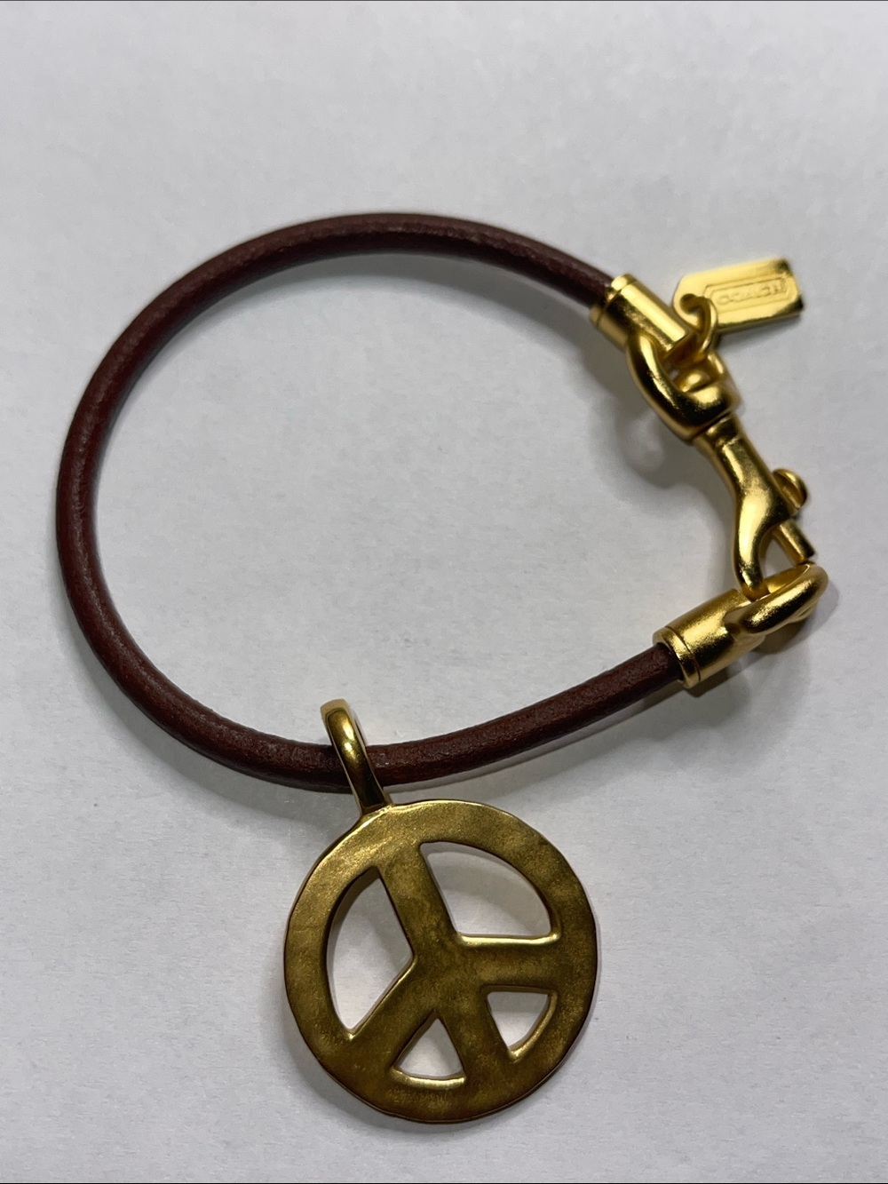 Coach Brown Leather Bracelet with Gold Peace Charm